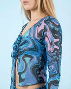 Glacial Sea Fairy rave top modeled from side showing flowing sheer sleeves and marbled blue pattern