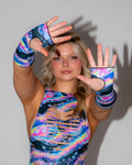 Acid Sky Gloves on a woman's hands, featuring swirling neon pinks, blues, and purples, perfect for rave festival fashion.