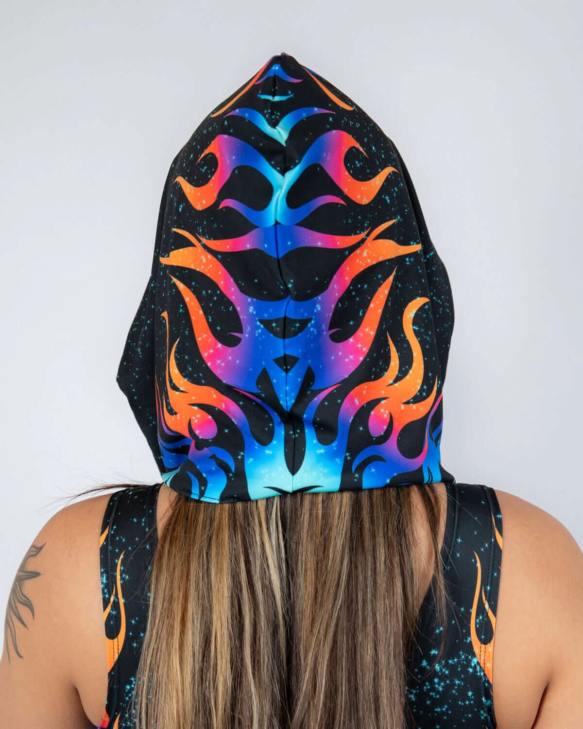Blaze Assassin Hood from the back, showcasing neon orange and purple flame graphics on a black cosmic rave hood.
