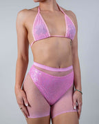 Front view of the Bikini Babe Rhinestone 2 Piece Fishnet Set in pink, featuring a model wearing the sparkly rave top and high-waisted shorts.