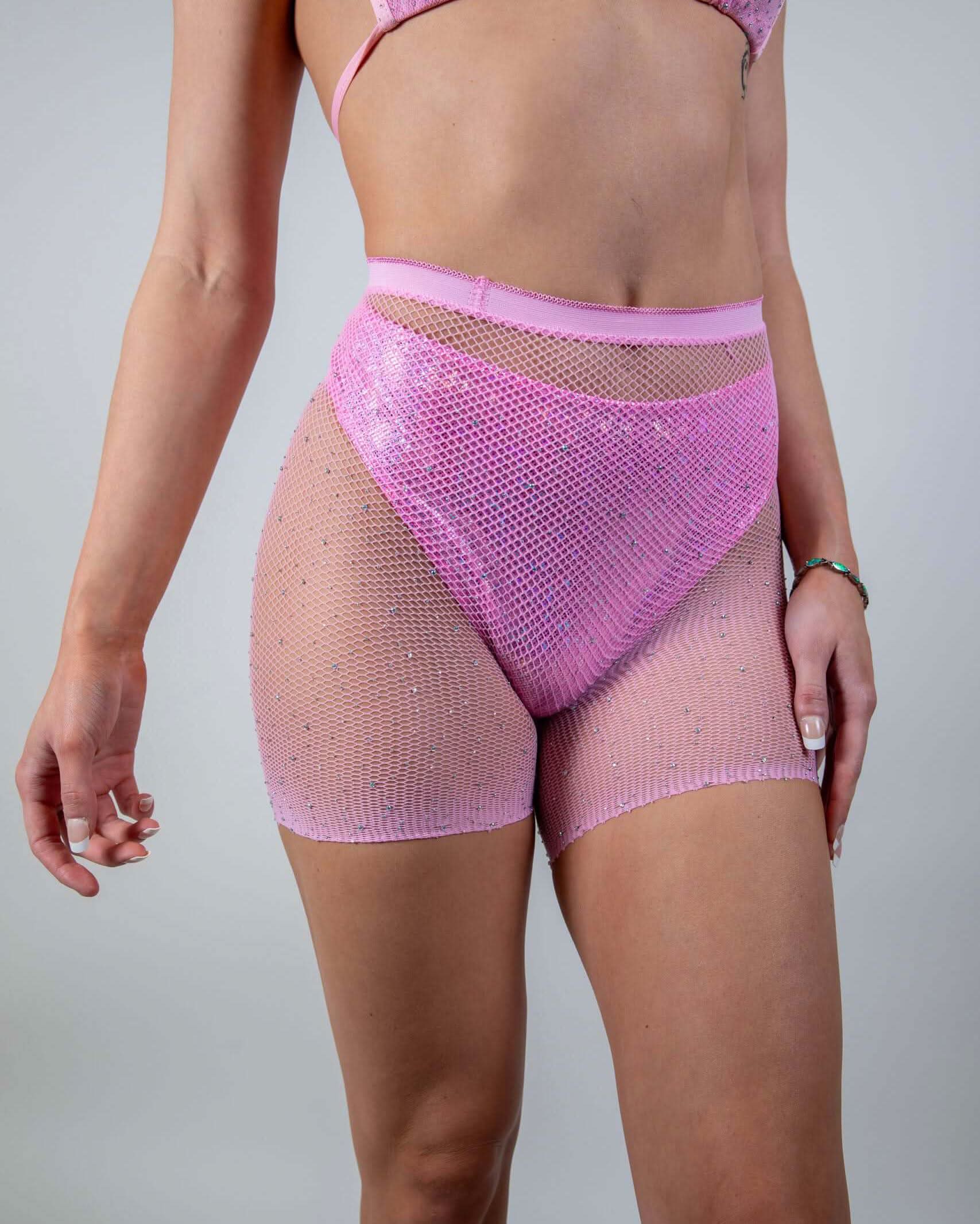 Bikini Babe Rhinestone 2 Piece Fishnet Set in pink, shown from the front on a model, highlighting the sparkling rave shorts.