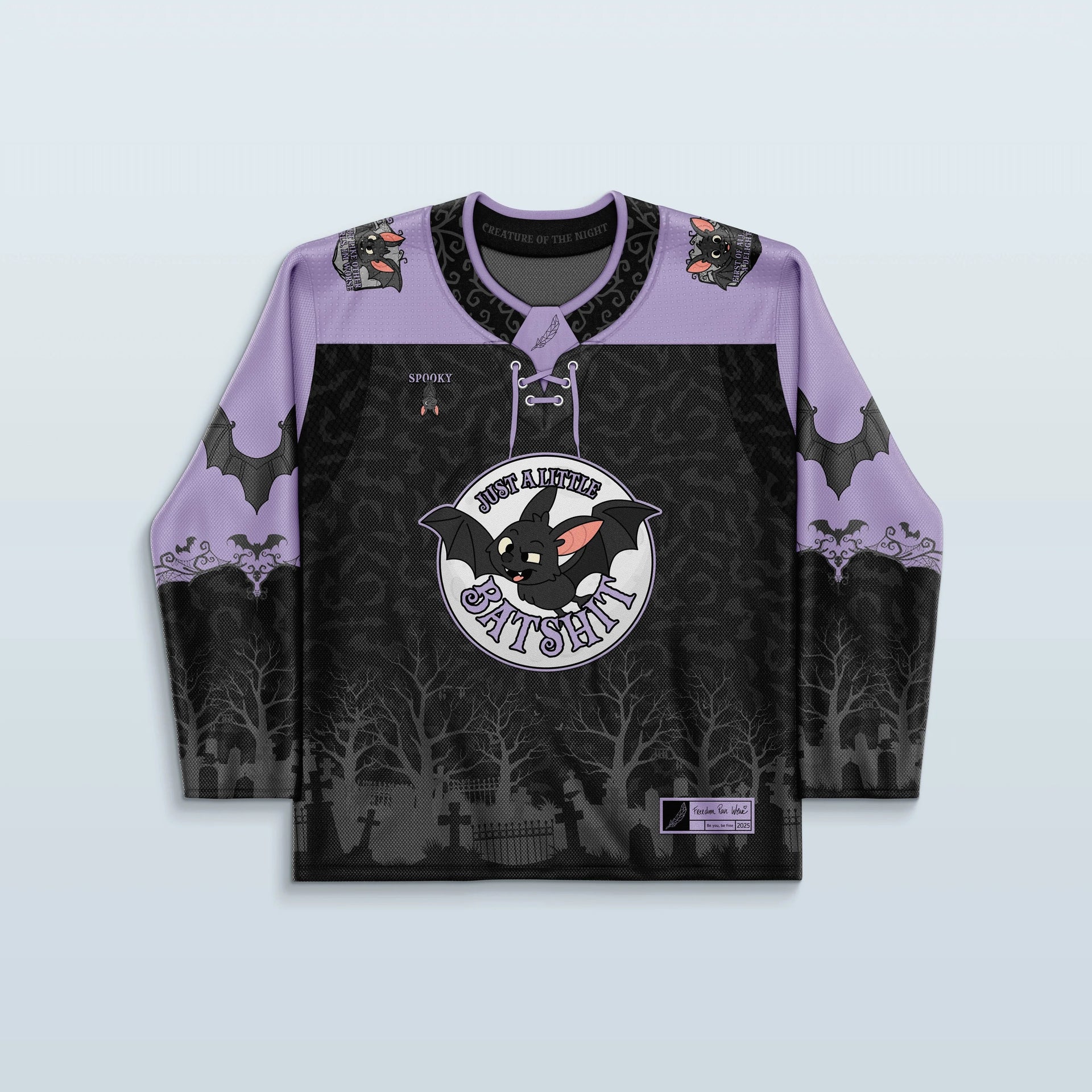 Front view of the Batshit Hockey Jersey, a limited edition rave top in lavender and black, featuring a cartoon bat crest and a haunted graveyard design.