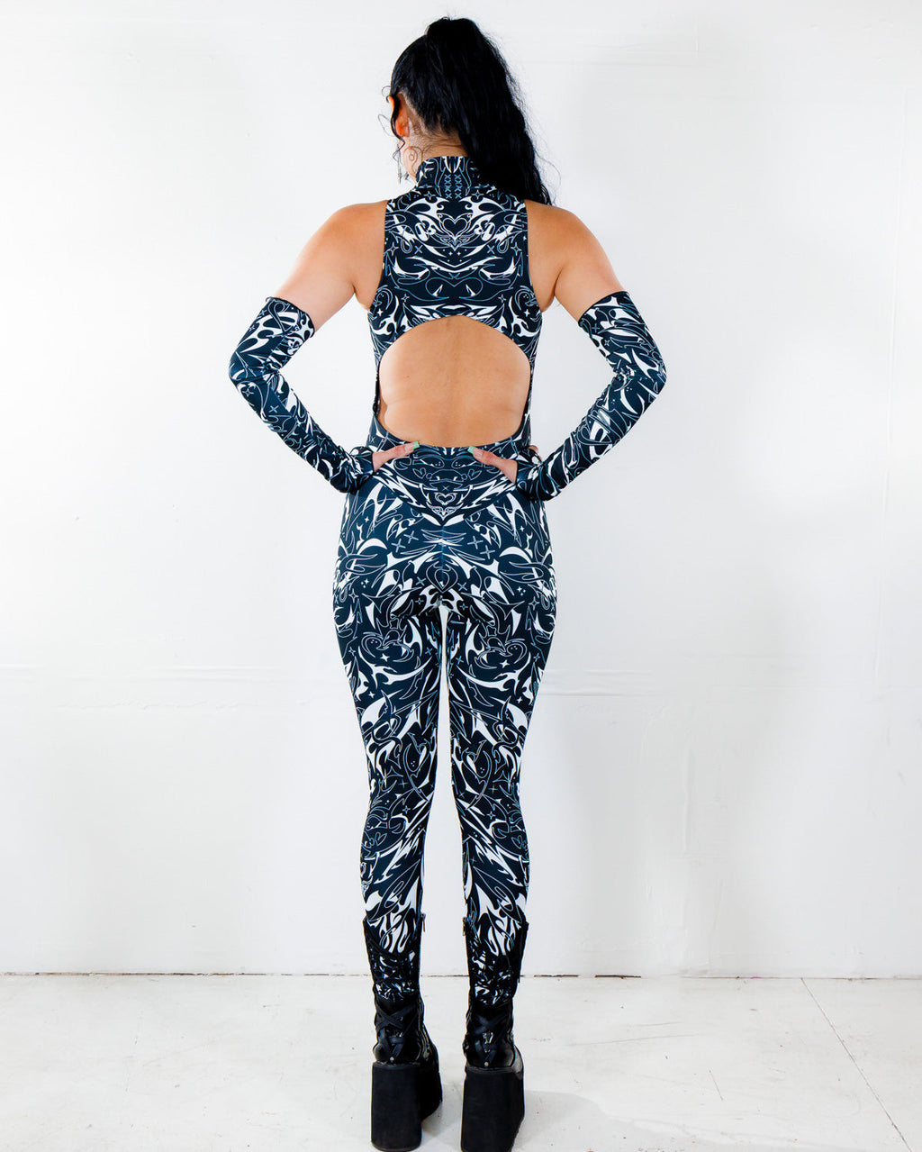 BLVDE Cold Shoulder Jumpsuit from the back, showing the black and white marble swirl print and open back cutout, perfect for a rave festival.