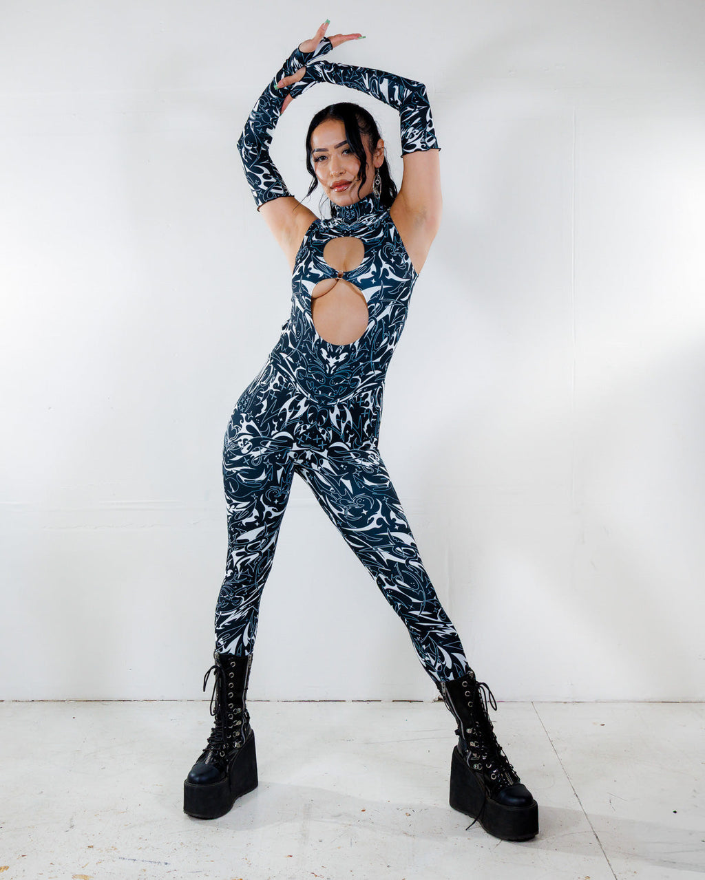 BLVDE Cold Shoulder Jumpsuit front view, featuring a black and white marble swirl print and architectural cutouts, perfect for rave festivals.