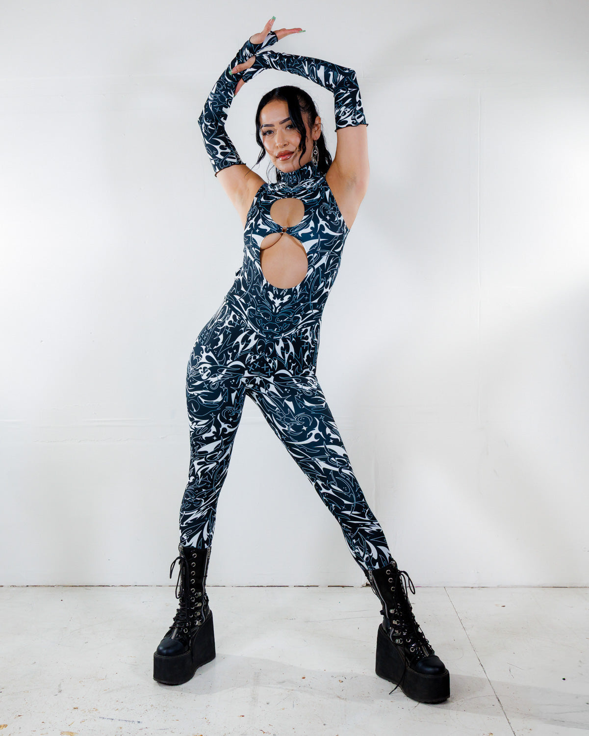 BLVDE Cold Shoulder Jumpsuit front view, featuring a black and white marble swirl print and architectural cutouts, perfect for rave festivals.