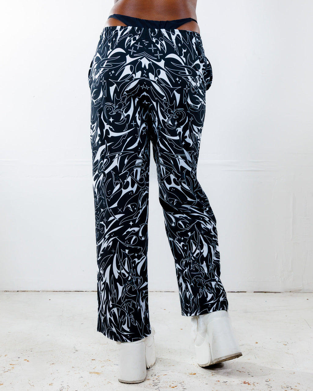 BLVDE Lucy Pants from the back, showing the hypnotic black and white marble swirl print, perfect for rave festivals.