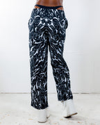 BLVDE Lucy Pants from the back, showing the hypnotic black and white marble swirl print, perfect for rave festivals.