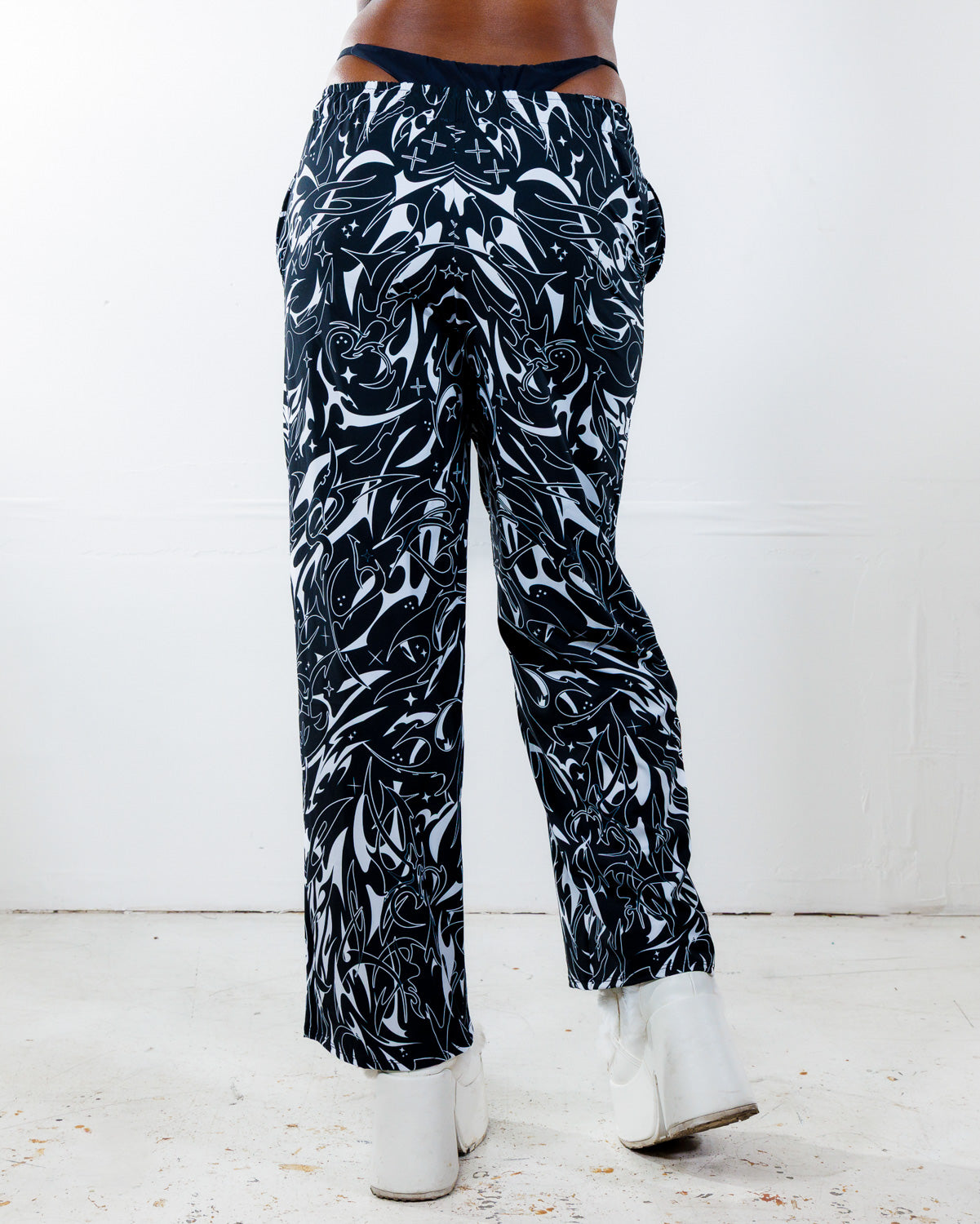 BLVDE Lucy Pants from the back, showing the hypnotic black and white marble swirl print, perfect for rave festivals.