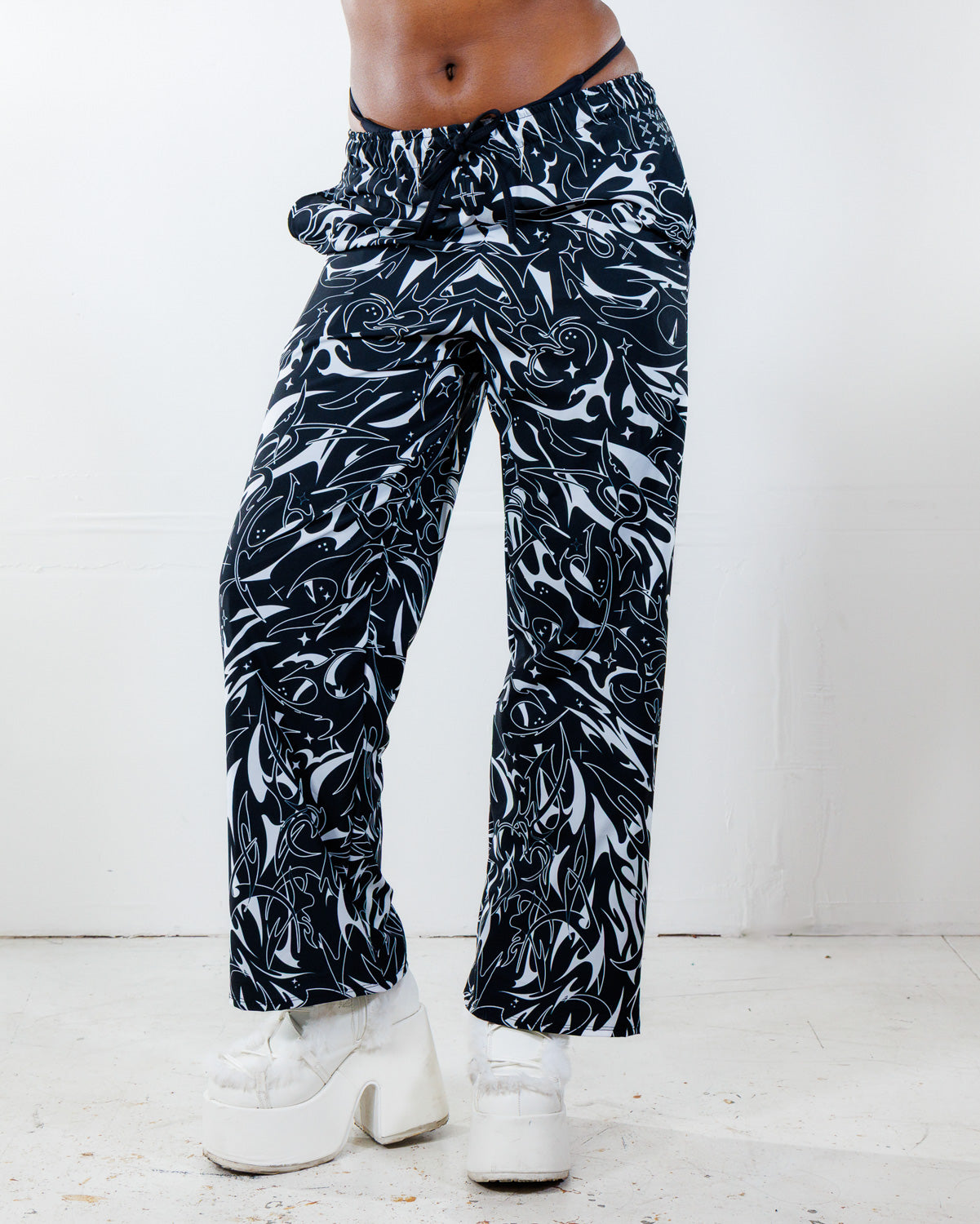 BLVDE Lucy Pants in black and white marble swirl print, shown from the front on a model, perfect for a rave or festival.