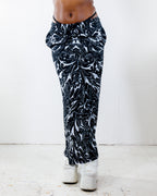 BLVDE Lucy Pants in black and white marble swirl print, shown from the front on a model, perfect for a rave or festival outfit.
