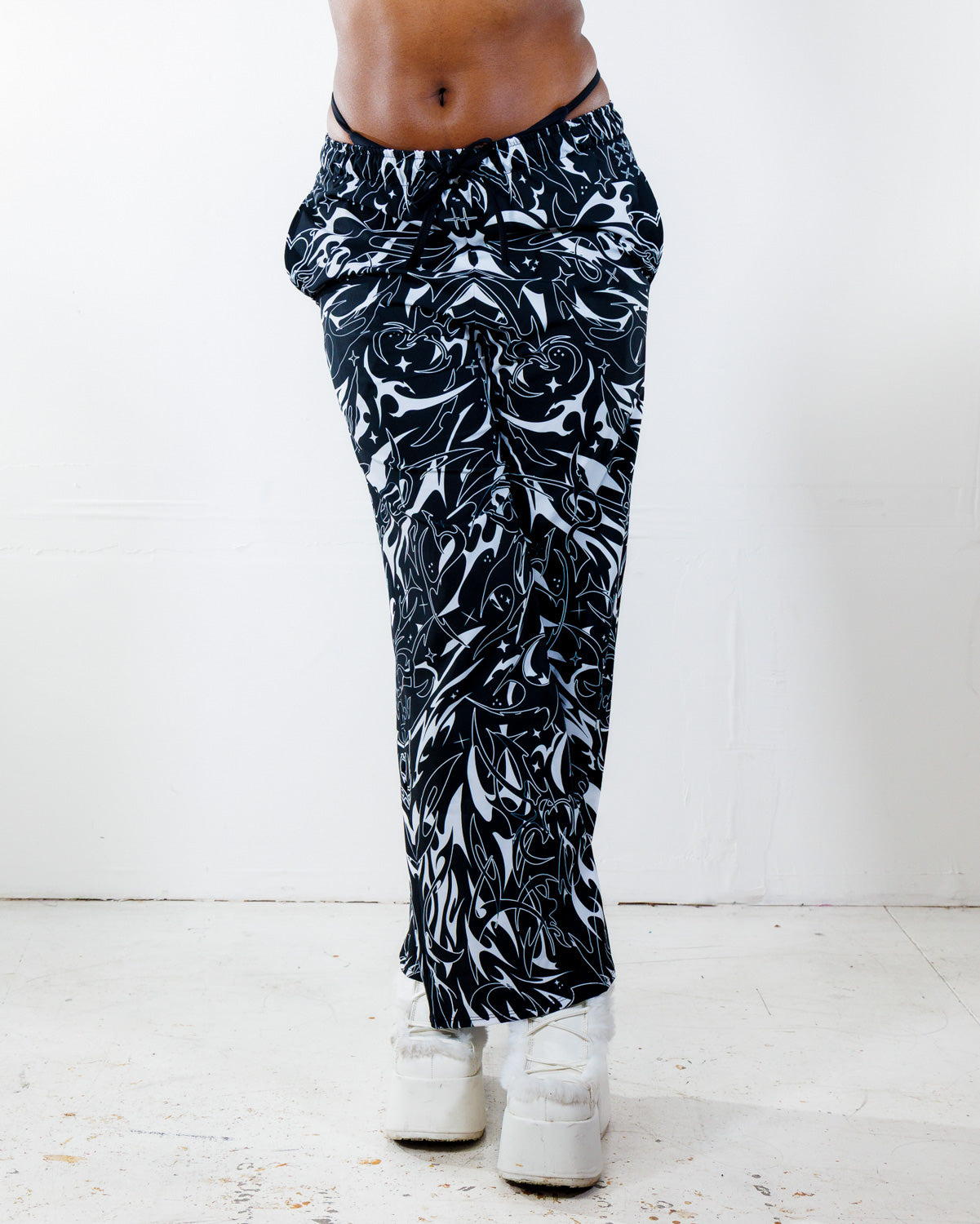 BLVDE Lucy Pants in black and white marble swirl print, shown from the front on a model, perfect for a rave or festival outfit.