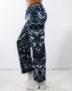 BLVDE Lucy Pants in black and white marble swirl print, shown from the side on a model, perfect for rave festivals.