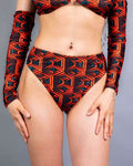Labyrinth high waisted rave pants with geometric pattern in red and black, festival outfit front view