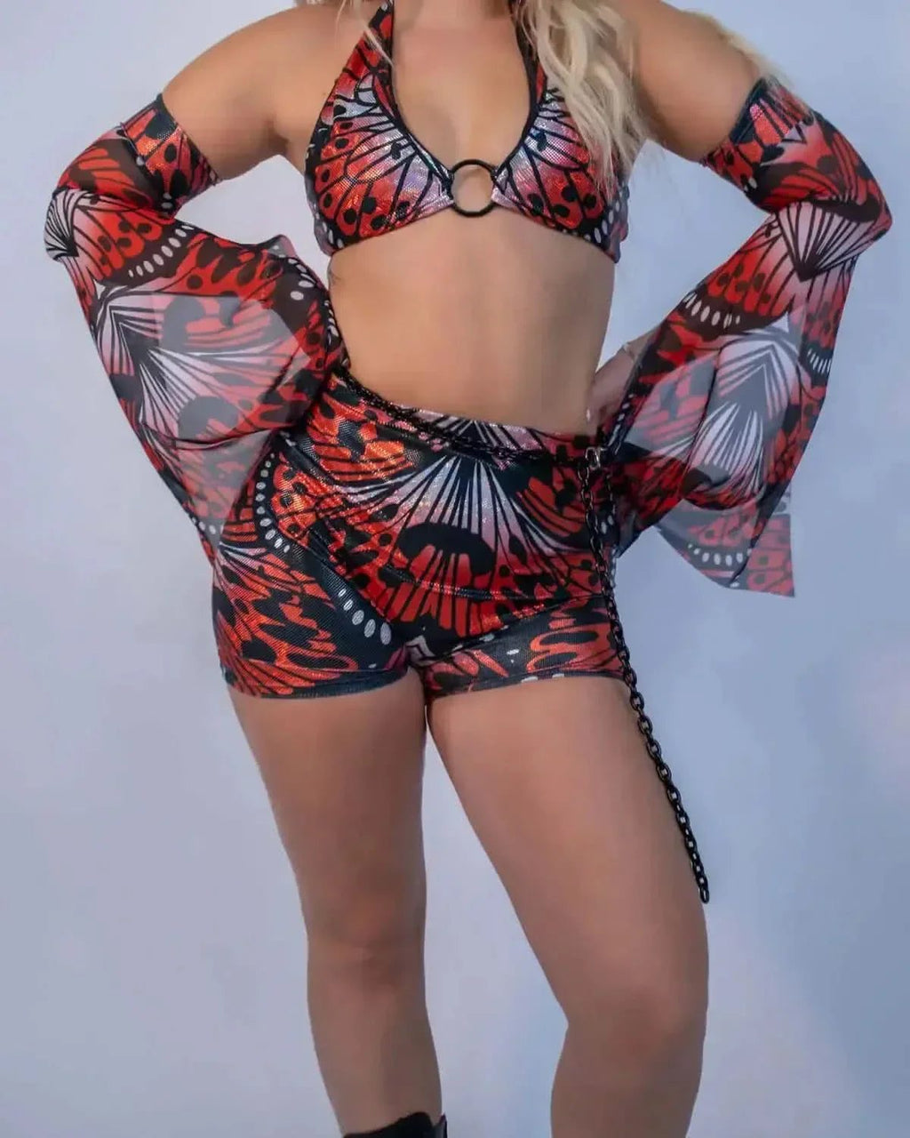 Red lacewing butterfly print rave pants and bikini top set with sheer sleeves front view