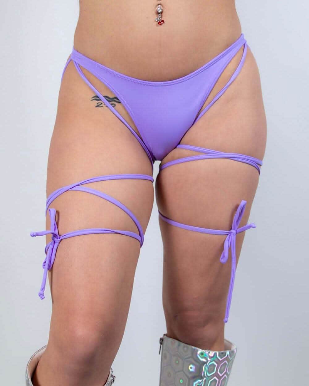 Lavender strappy high hip rave pants with leg harnesses modeled from front view for festival outfit styling