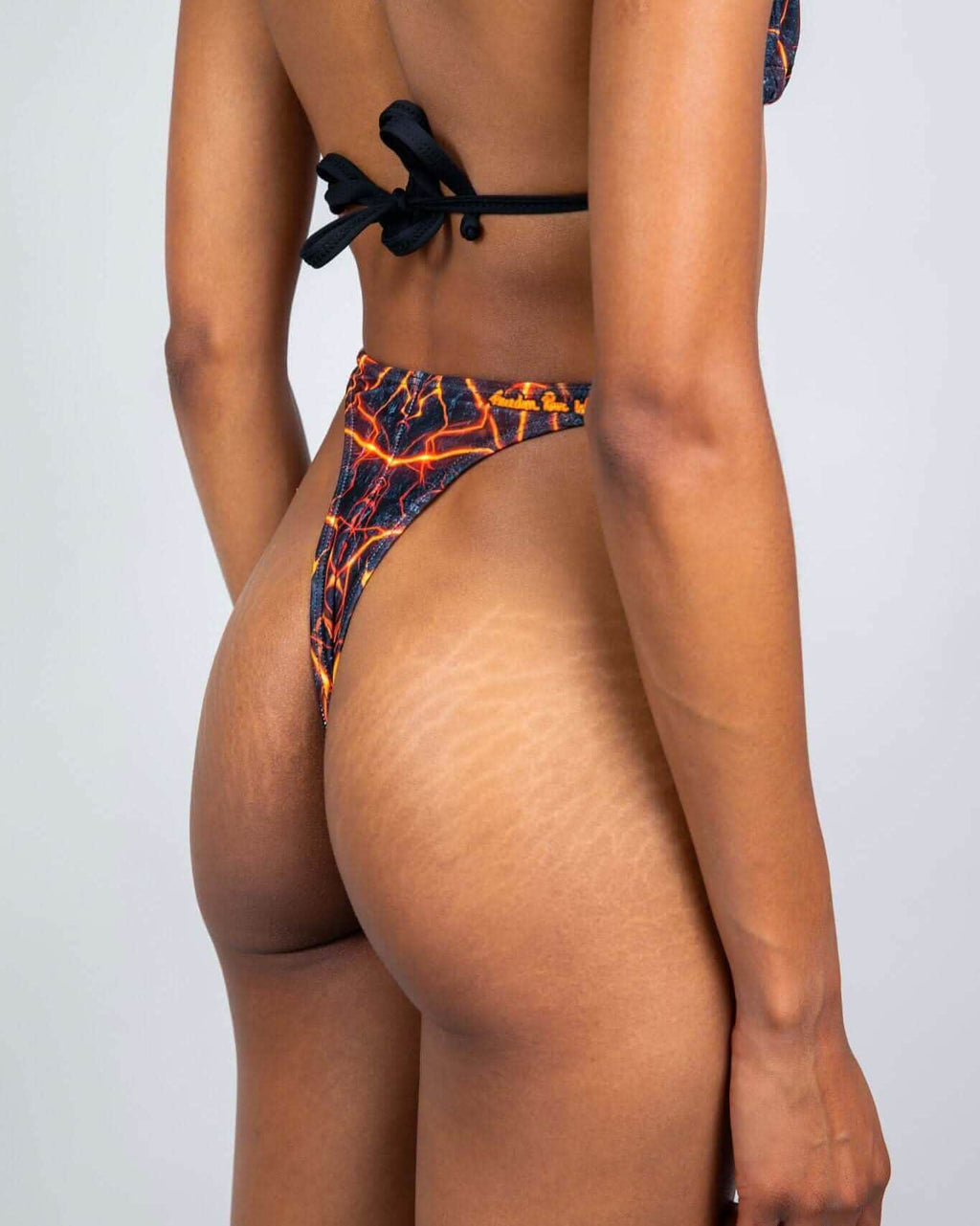 Magma print rave pants thong bottoms back view showing high-waisted cut and festival-ready fiery pattern