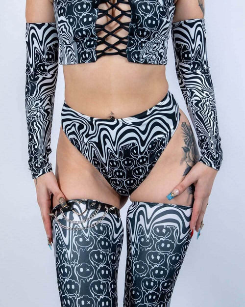 Black white melty smiley face rave pants high waisted thong with matching crop top and accessories front view