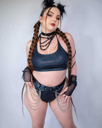 Model wearing midnight metallic rave pants and top with chain details in festival outfit front view