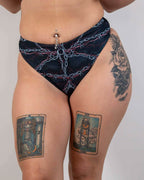 Purgatory high waisted rave thong bottoms with chain print in black, front view festival outfit