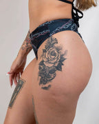 Purgatory high waisted rave pants with chain print shown in side view, festival outfit with dark edgy style