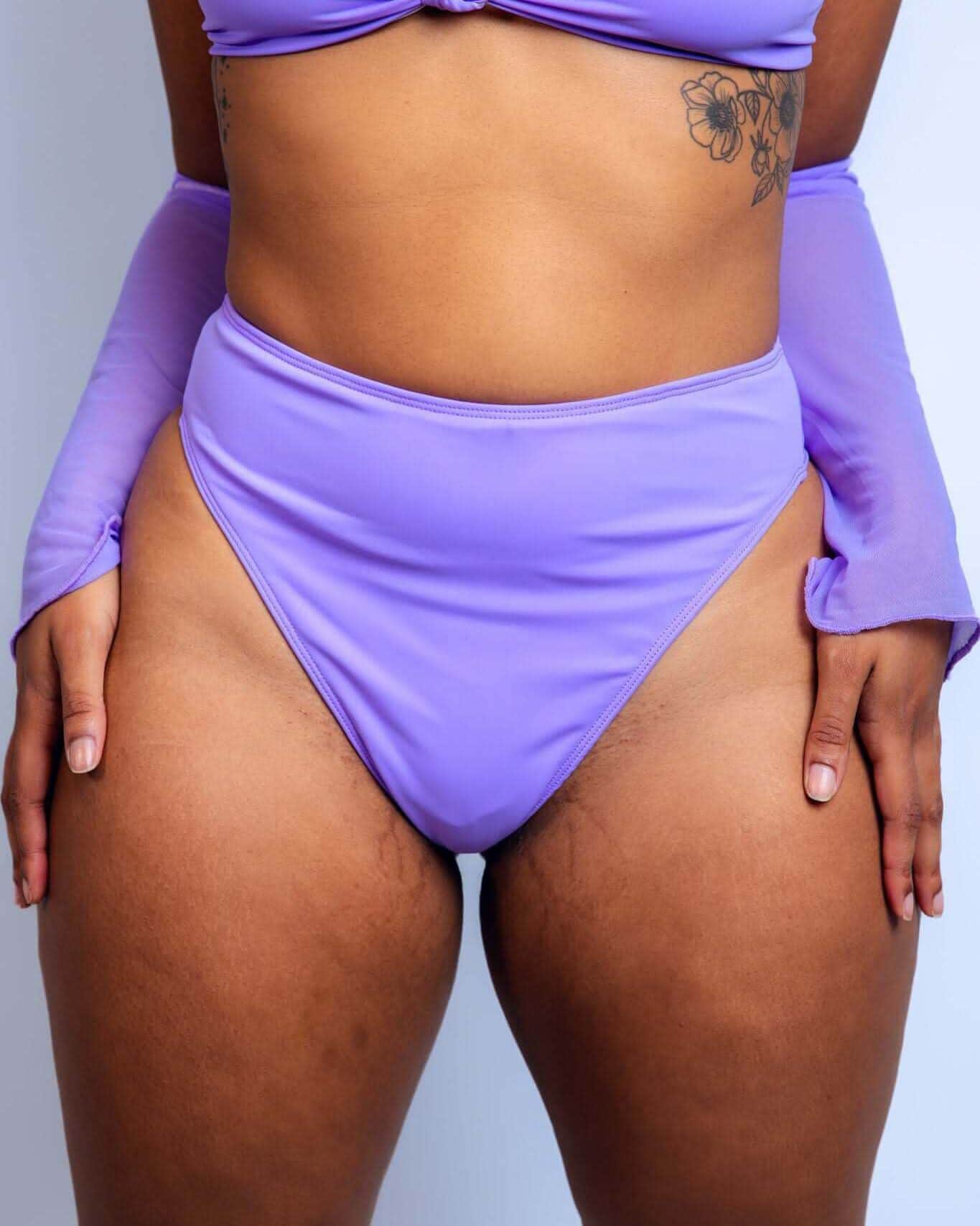Purple high waisted rave pants thong bottoms front view festival outfit on model