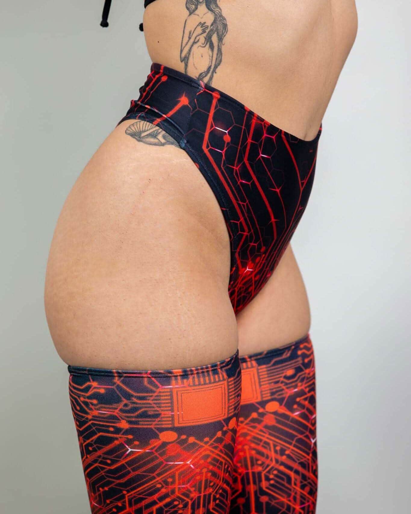 Red Singularity high waist rave pants with circuit pattern - side view festival outfit styling