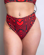 Red Void high waisted thong rave pants with psychedelic red and black swirl pattern festival outfit
