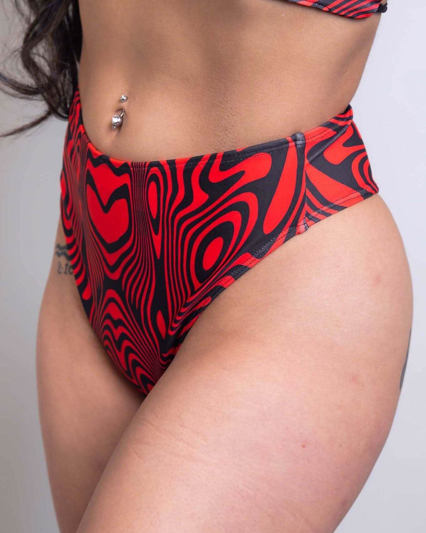 Red Void high waisted thong rave pants with psychedelic swirl pattern - festival outfit front view
