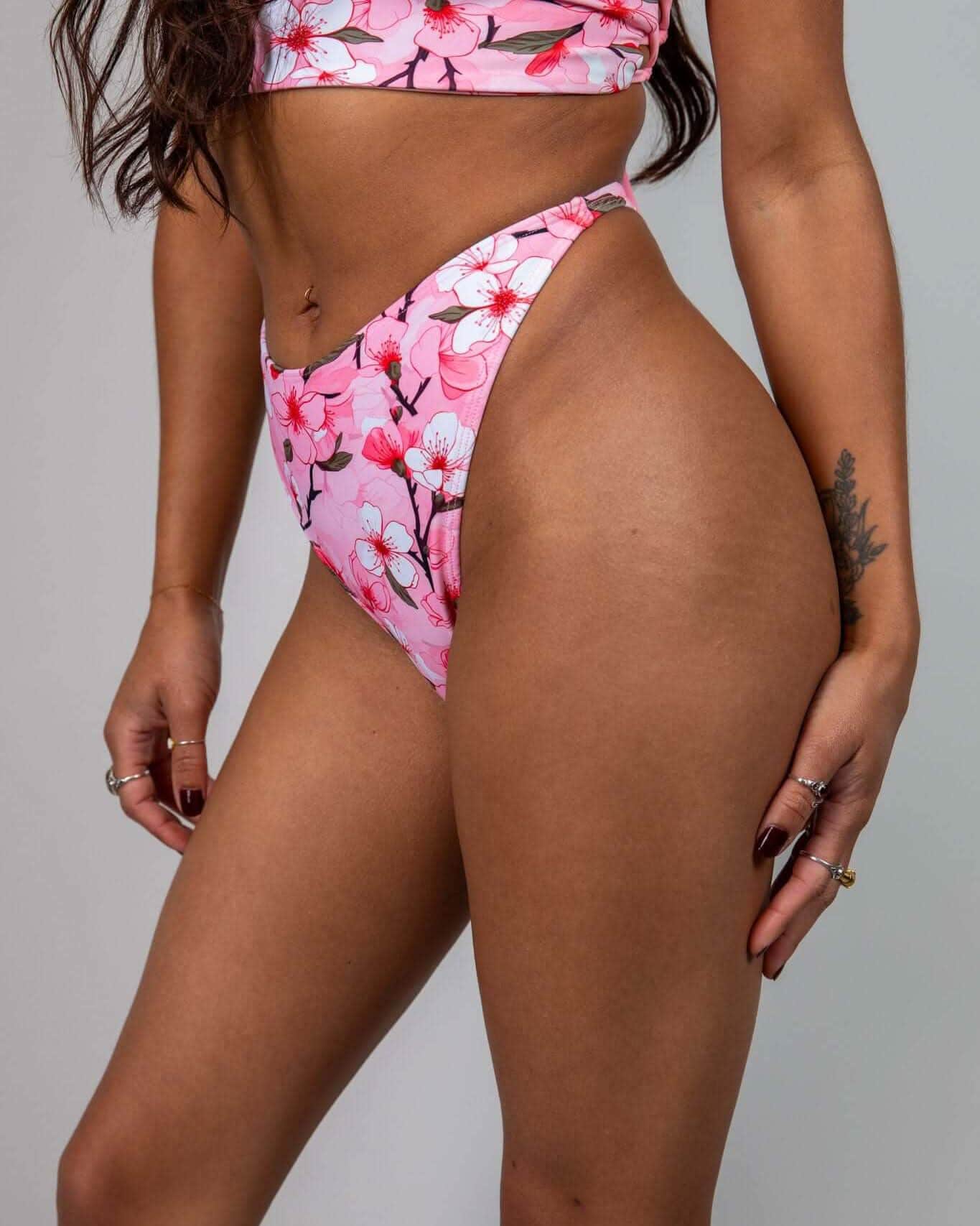 Pink Sakura cherry blossom rave pants bottoms front view on model festival outfit