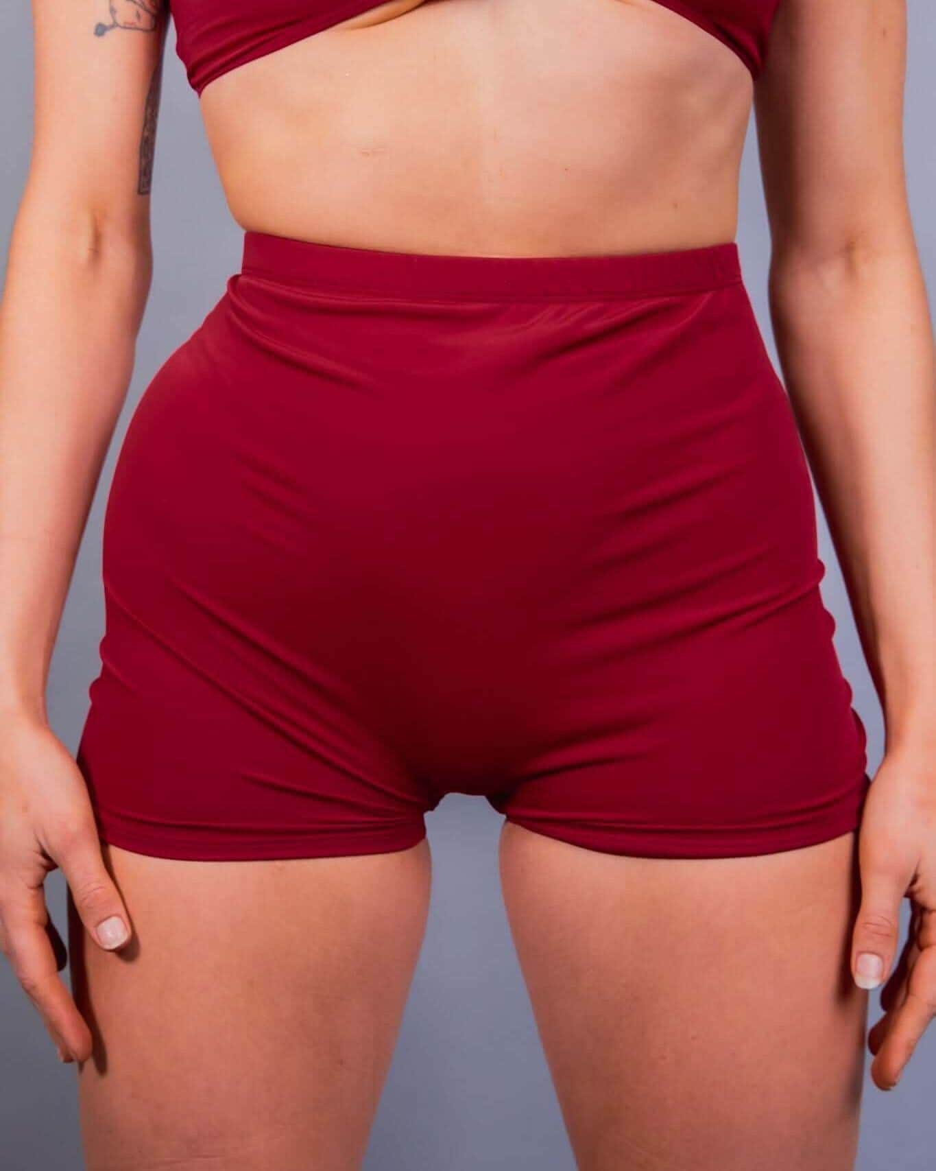 Scarlet red rave pants high waisted shorts festival outfit front view on model