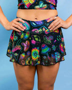 Colorful psychedelic Shroomie mesh skort rave pants with neon mushroom print, front view festival outfit