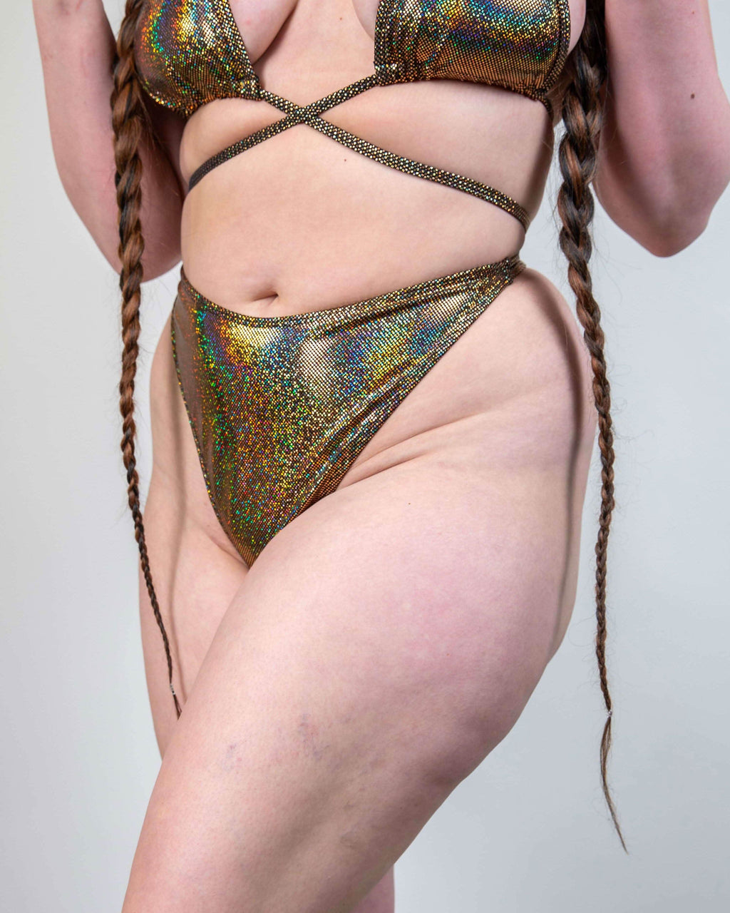 Starfire holographic gold rave pants bottoms detail shot showing shimmer finish and retro high-hip styling