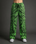 Techtronix Lucy Pants in neon green and black, featuring an angular circuit pattern, shown from the front on a model for rave festival fashion.