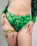 Green toxic pattern rave pants high waisted Brazilian cut festival outfit front view