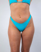 Turquoise Siren Risk rave pants bikini bottoms front view festival outfit on model