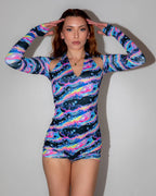 Acid Sky Afters Romper front view, a rave bodysuit in swirling neon pink, blue, and yellow-green pattern.