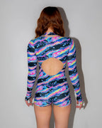 Acid Sky Afters Romper from the back, featuring a vibrant multicolor liquid light pattern and a stylish back cutout, perfect for rave festivals.