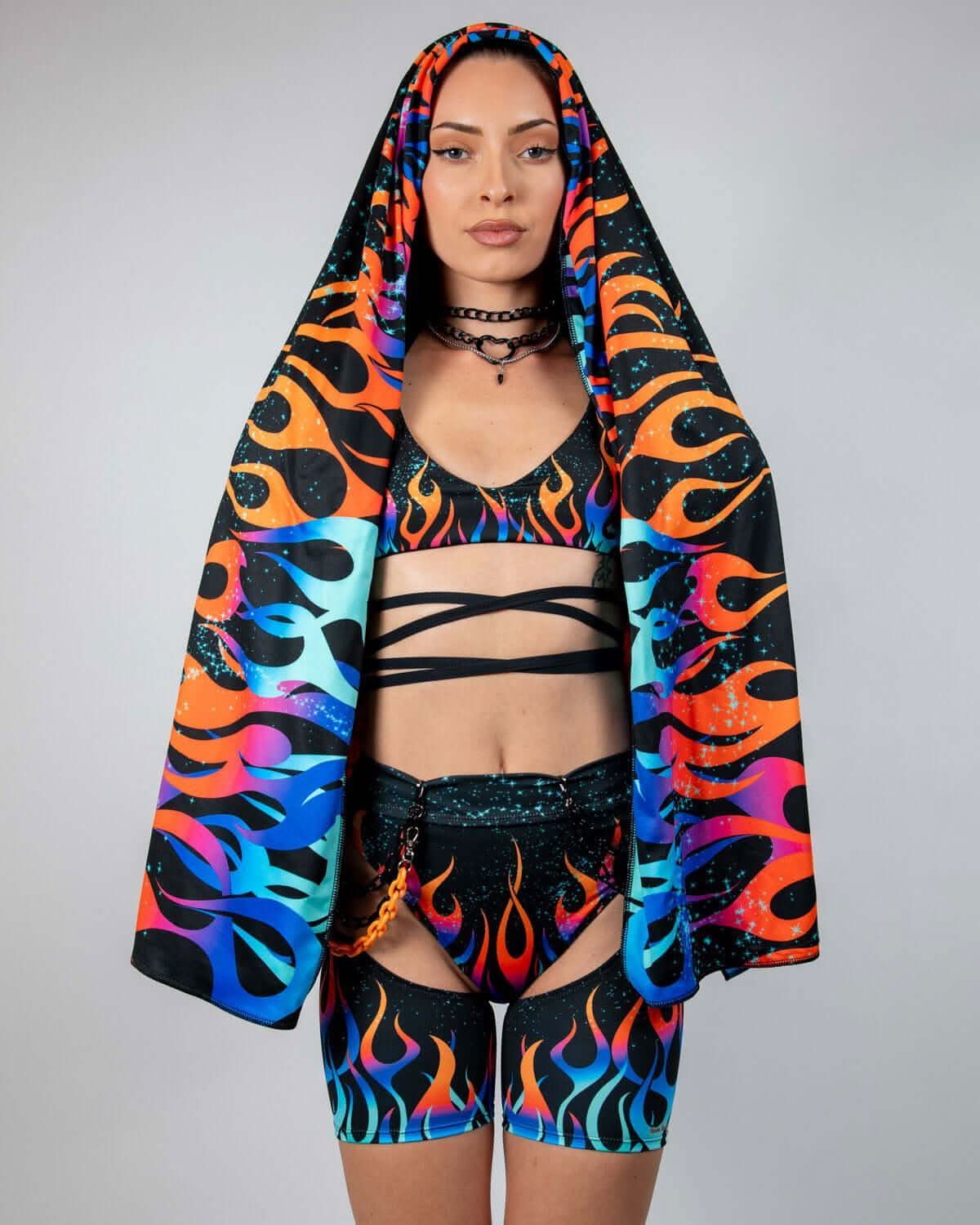 Blaze Festival Scarf draped over a model's head and shoulders, showcasing the neon flame pattern on black, perfect for rave outfits.