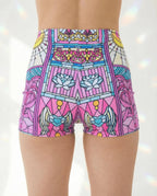 Moonlight High Waist Shorts from the back, showcasing the pastel pink, teal, and yellow stained-glass rave pattern.