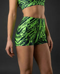 Techtronix High Waist Shorts in neon lime circuitry pattern, seen from the side on a model, perfect for rave festivals.