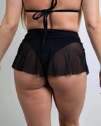 Black mesh micro rave skirt back view showing flared skater silhouette and sheer fabric detail