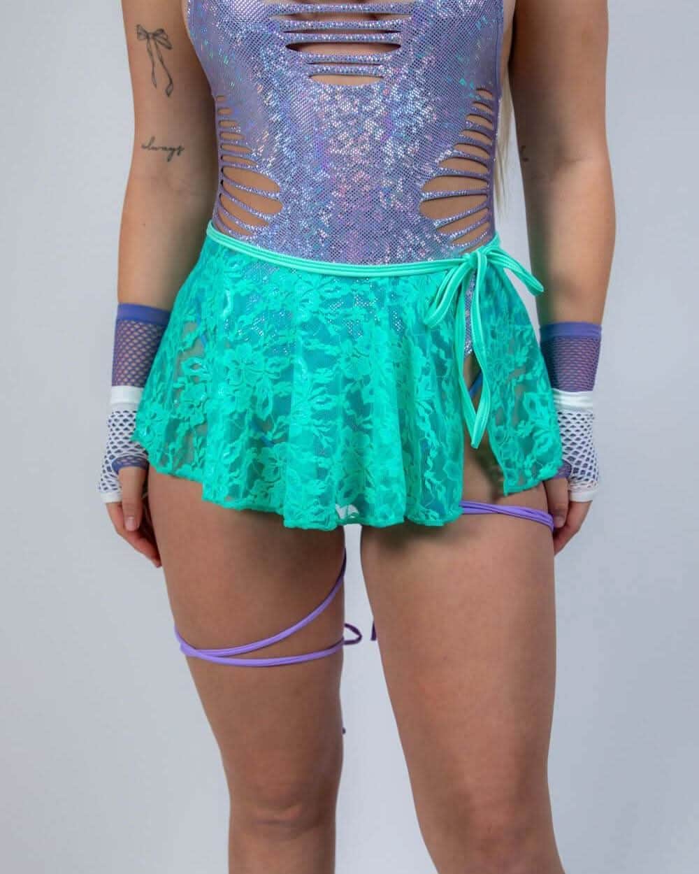 Calypso Lace Swirl rave skirt in turquoise worn with purple sequined festival top front view