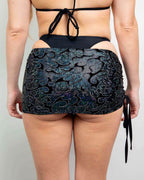 Hellcat Cinch rave skirt back view showing holographic iridescent fabric with adjustable side ties for festival outfits