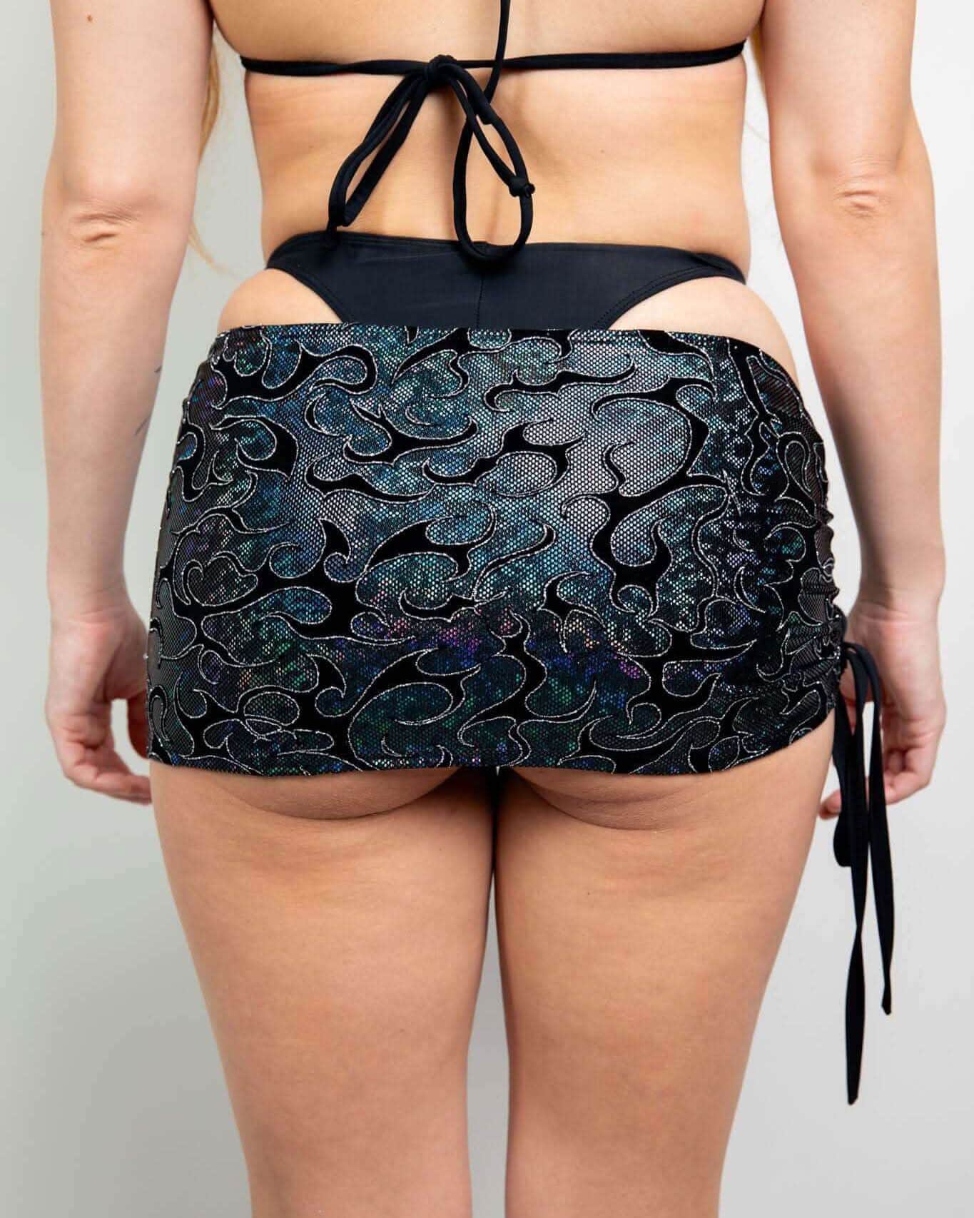 Hellcat Cinch rave skirt back view showing holographic iridescent fabric with adjustable side ties for festival outfits