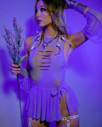Model styling lavender mesh swirl rave skirt in purple lighting holding flowers lifestyle shot