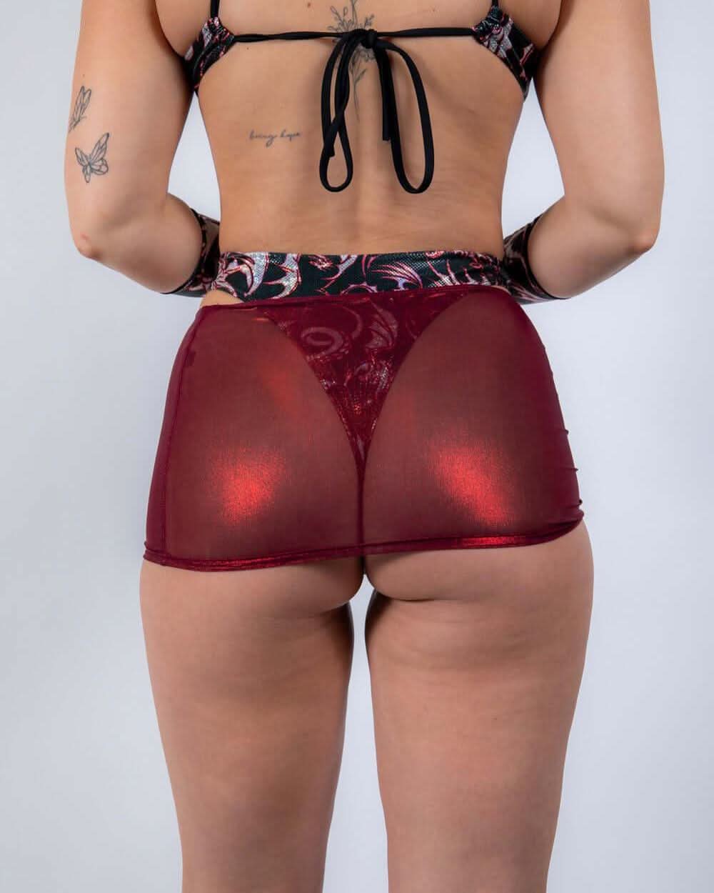 Back view of red holographic Heartbreaker mesh rave skirt with lace panel detail and festival outfit styling
