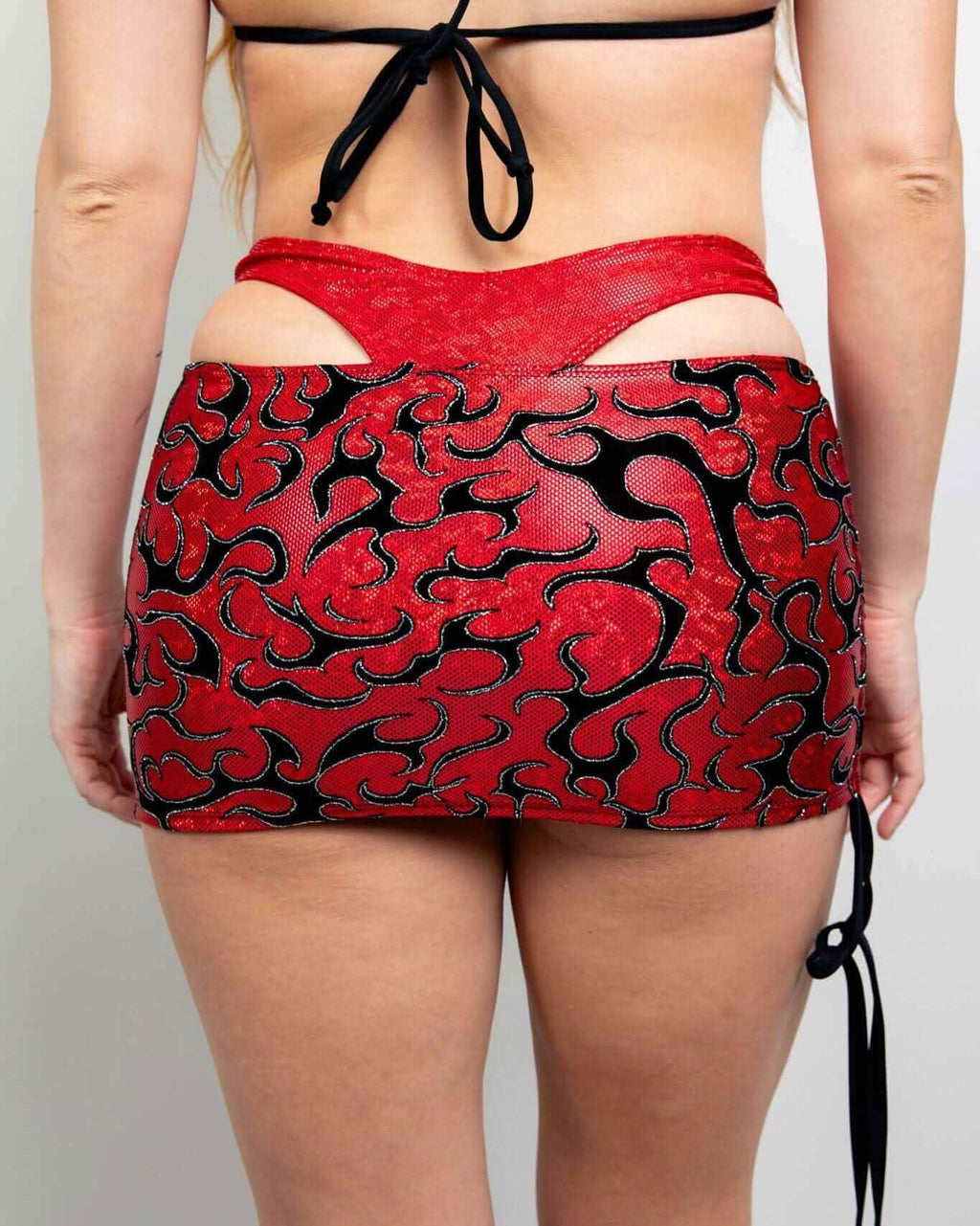 Red sequined Inferno rave skirt with black flame pattern and adjustable cinch ties, back view