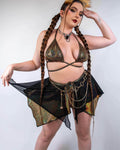 Model wearing Starfire golden holographic rave skirt with black mesh overlay in festival outfit front view
