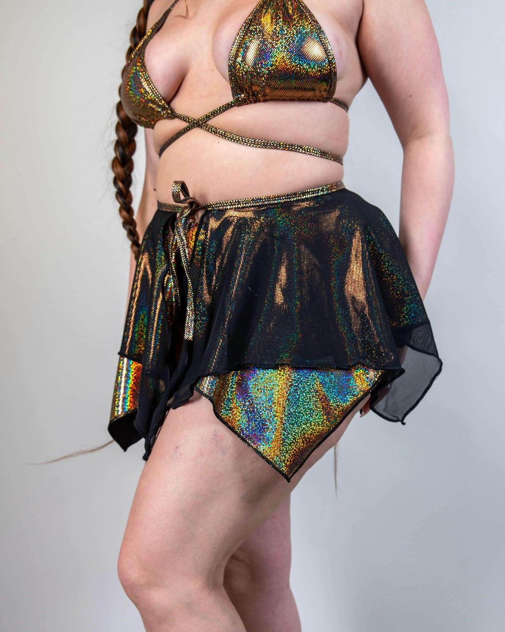 Starfire holographic rave skirt with black mesh overlay worn by model against white background