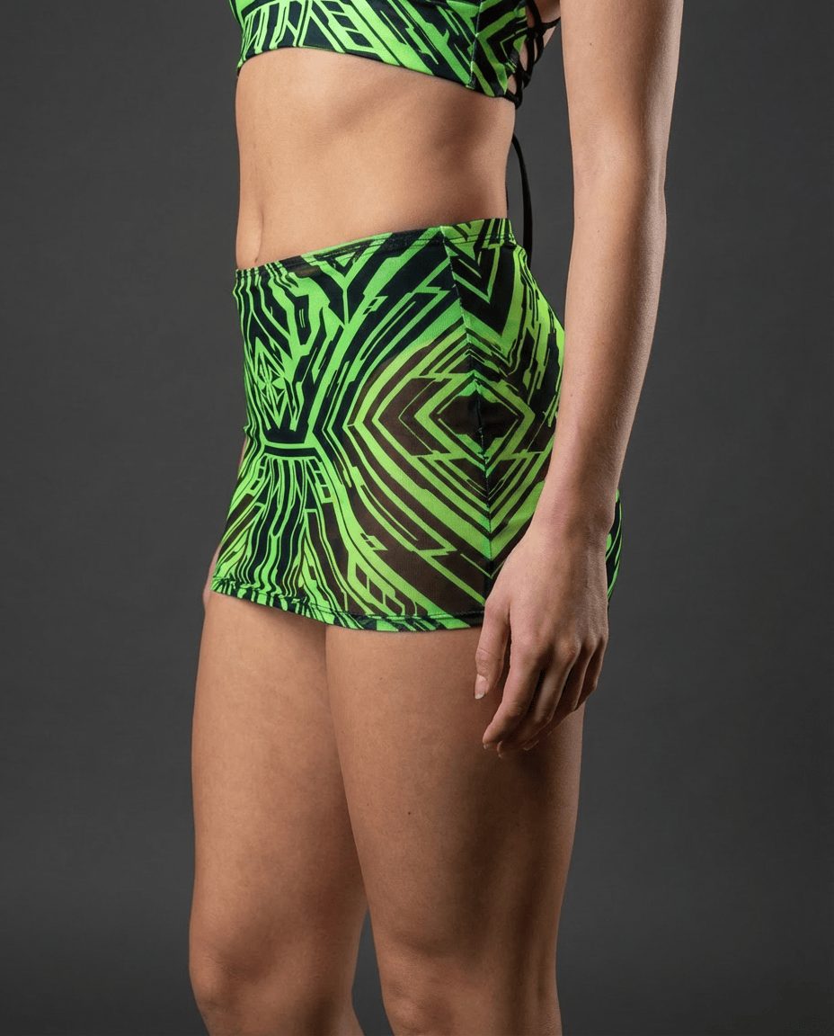 Neon green Techtronix rave skirt with geometric black pattern worn by model in side pose